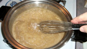 Continue to whisk over medium heat to blend together roux and broth.